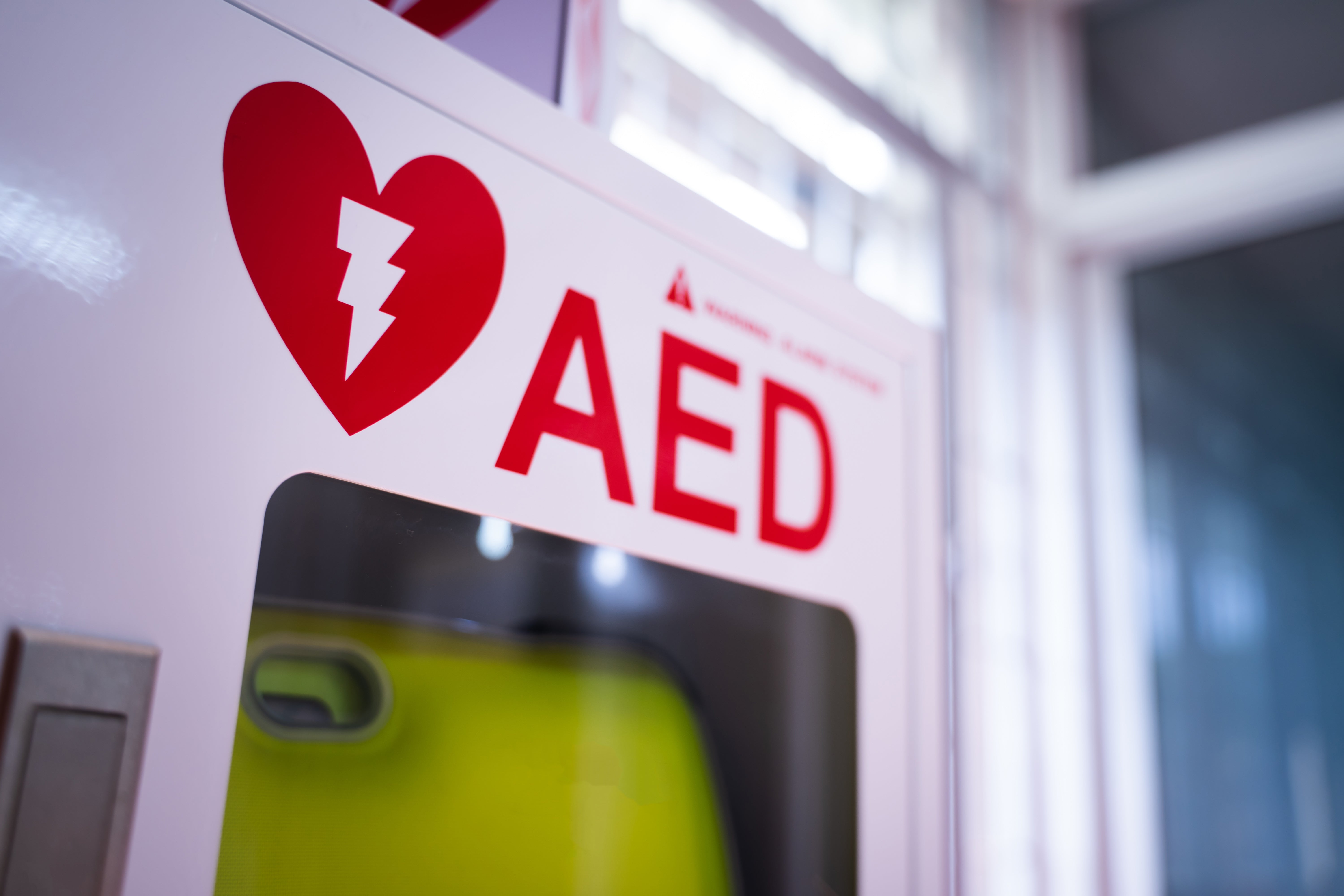 Clearly marked wall-mounted AED cabinet on campus.